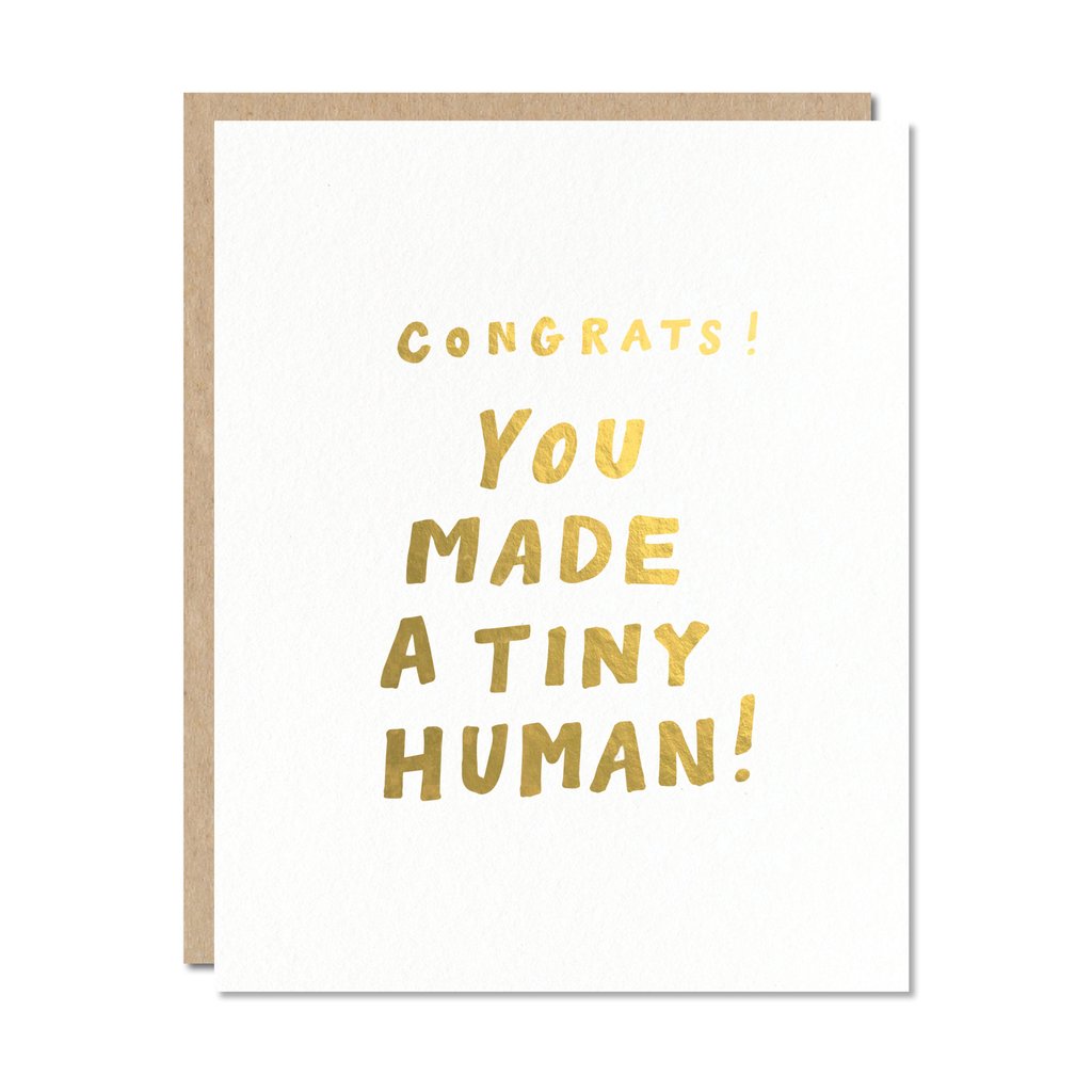 Gold foil handwritten text on white card, reading: Congrats! You made a tiny human.