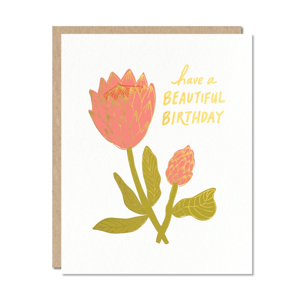 Pink flower with green stems and leaves and gold foil on white card with text reading: Have a beautiful birthday.