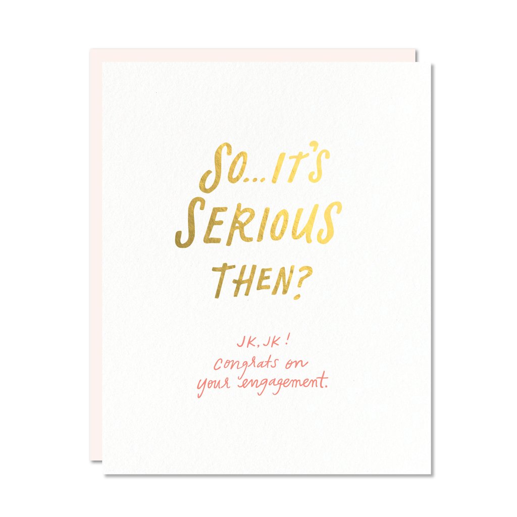 Gold foil and red handwritten text on white card, reading: So it’s serious then? JK, JK. Congrats on your engagement.