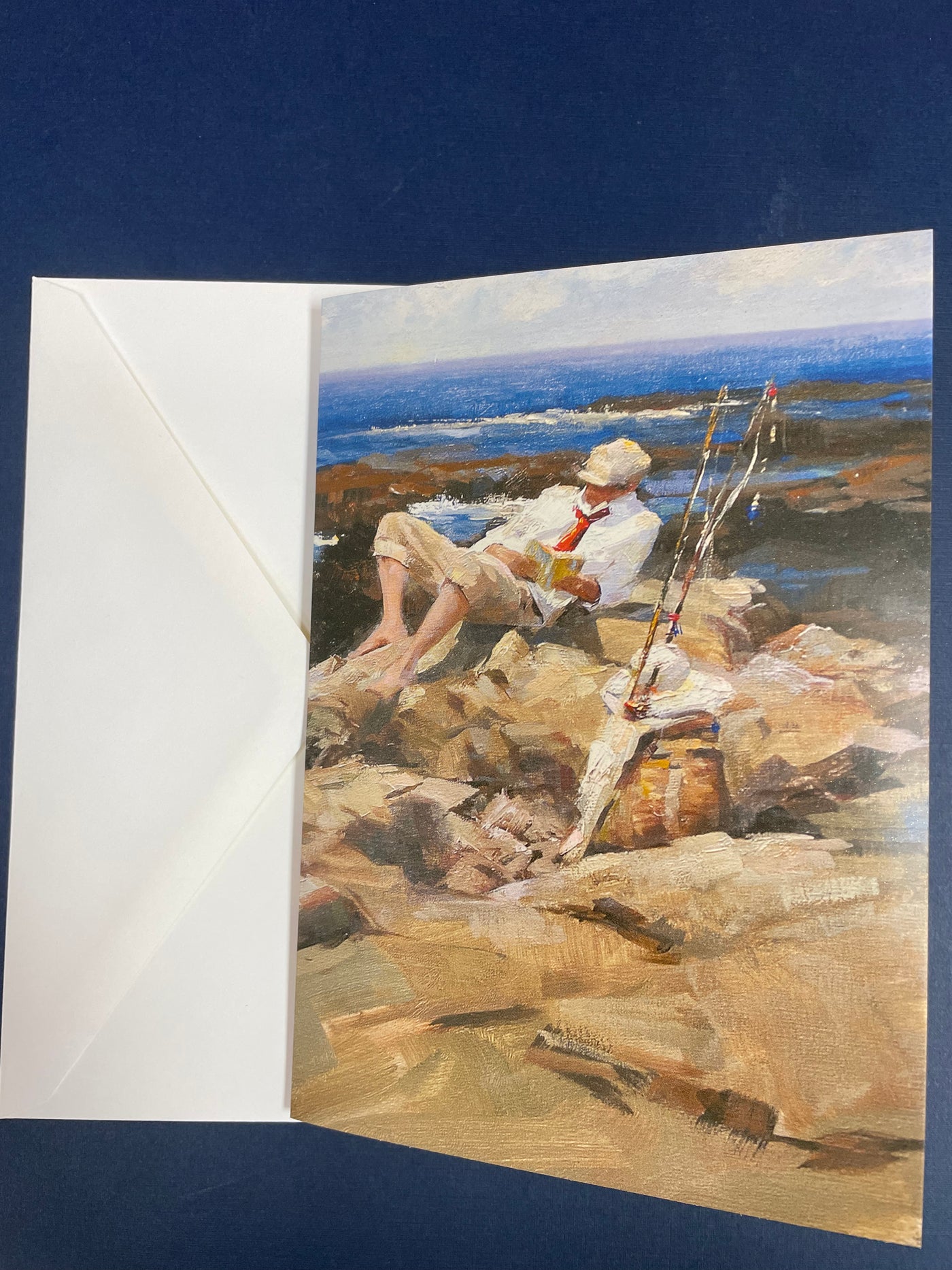 Man Fishing and Reading on the Rocks